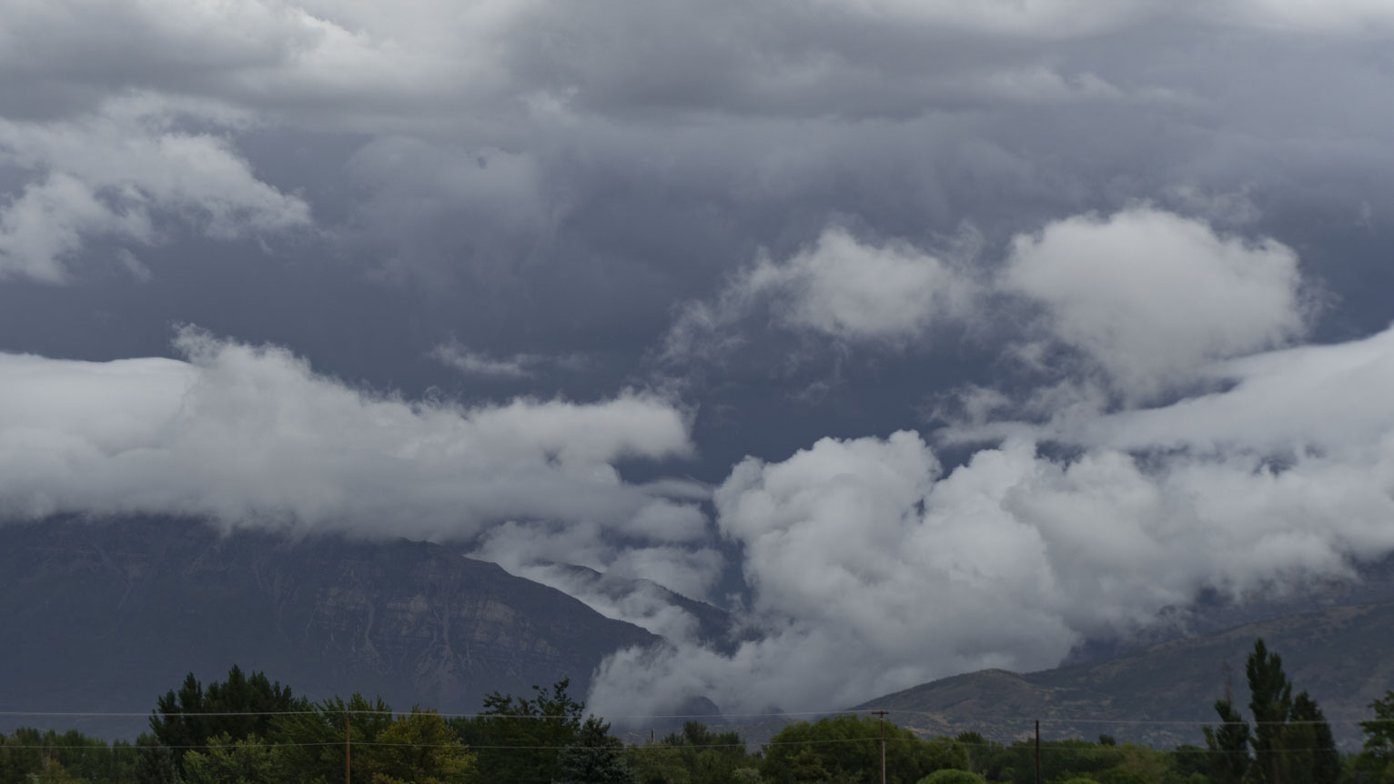 Foggy clouds seem to drip down the mountains